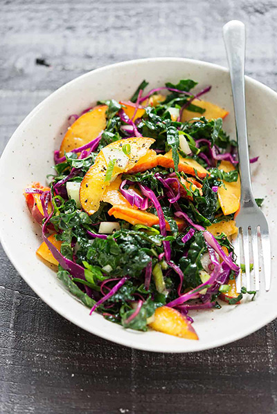 Salad of wilted kale, peaches, and red cabbage