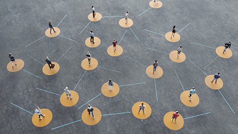 Aerial view of people standing on yellow circles with lines connecting the circles.