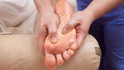 Foot massage being given to the sole of a foot 