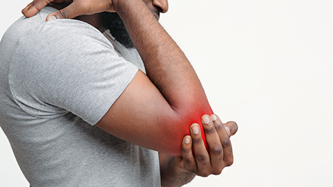 Elbow pain shown as painful red glow on a man's elbow