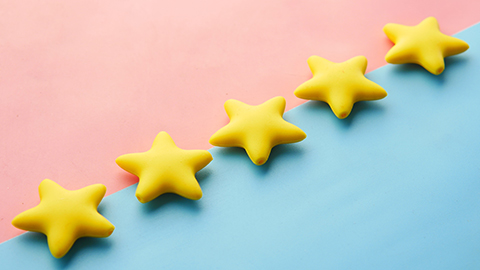 5 yellow stars laying across a pink and blue background.