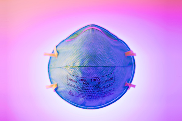 N95 surgical/dust mask on pink and purple background