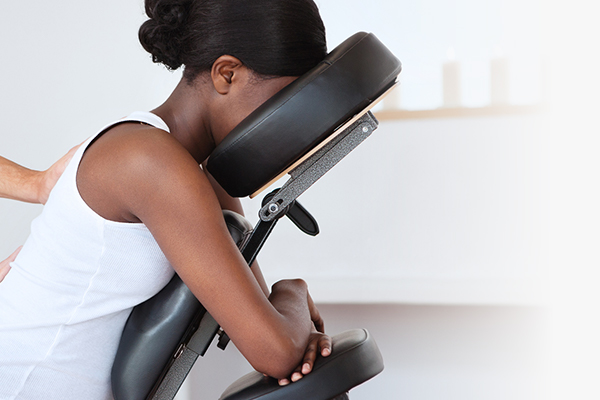 Black woman receiving a chair massage