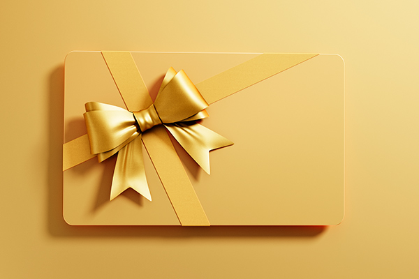 A gold gift box with gold ribbon on a gold background.