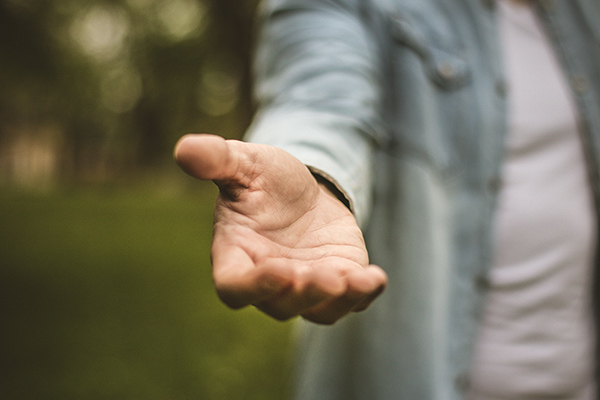 A man reaching out his hand to help. 