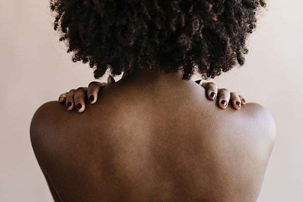 An African-American woman's back facing the camera 