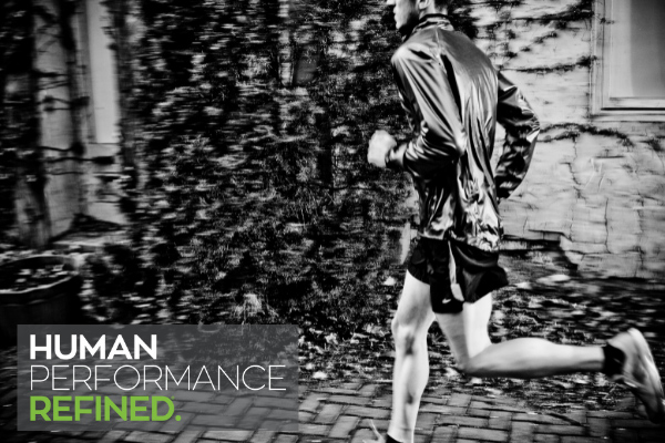 Black and white image of man running with "Human Performance Refined" caption. 