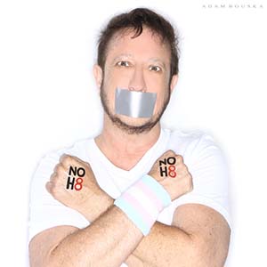 Transgender man posing with duck tape over mouth and "No H8" (No Hate) written on their hands