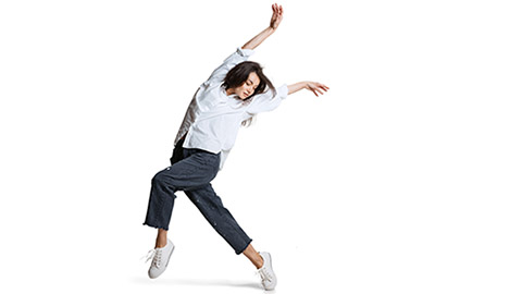 An image of a woman in a dance pose against a white background.