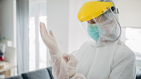 A person wearing full personal protective equipment