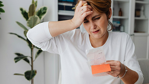 Image of a person stressed looking at a receipt.