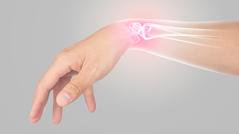 Sore wrist joint glowing pink on image of hand