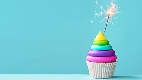 Rainbow cupcake with a sparkler candle
