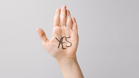 "Yes" written in black marker on an open palm. 