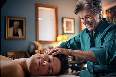 Author Briah Anson massages a client's head.